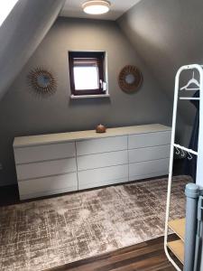 a room with a white dresser and a mirror at fewo-friends in Reinfeld +50 photos