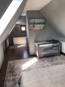 a attic room with a bed and a staircase at fewo-friends in Reinfeld