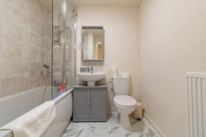 a bathroom with a toilet and a sink at Pass the Keys Modern comfortable House in Elswick +44 photos