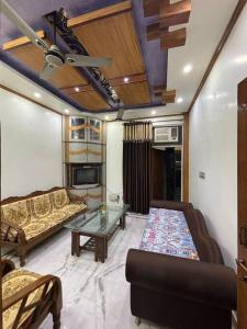 uma sala de estar com um sofá e uma mesa em Entire House- Ground Floor- Raj Villa em Kanpur