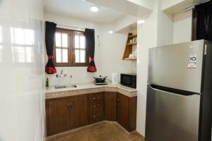 a kitchen with a refrigerator and a sink at Bishram Apartments in Pātan