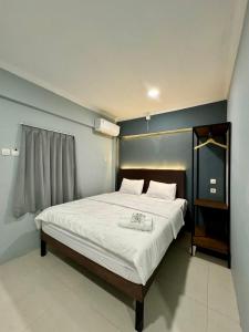 Tempat tidur dalam kamar di Torisan Hotel