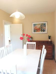 a dining room with a table and chairs and a painting at Casa Calvo in Viveiro