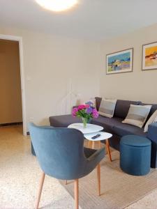 a living room with a couch and a table with flowers at Casa Calvo in Viveiro +28 photos
