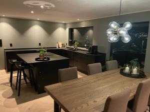 a kitchen and dining room with a table and balloons at Villa close to Granåsen in Trondheim