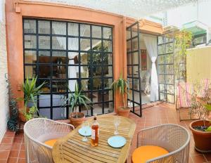 a patio with a table and chairs on a balcony at Loft a 5min de la playa in Valencia +43 photos