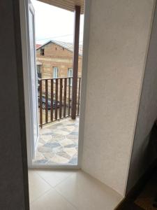 an open door to a balcony with a view at GuestHouse LILIA &Wine Celler in Telavi