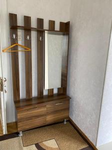 Vestidor de madera con espejo en una habitación en GuestHouse LILIA &Wine Celler, en Telavi