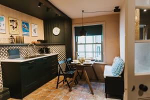 a kitchen with a table and a dining room at Cobblers Cottage Brigg in Brigg