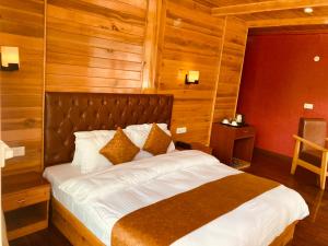 a bedroom with a large bed with wooden walls at Saksham INN in Jaipur