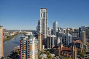 a city skyline with tall buildings and a river at Mantra on Queen in Brisbane