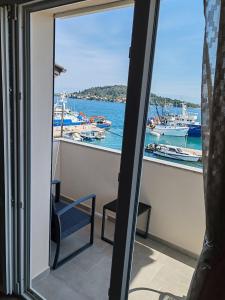 uma vista para uma marina a partir de uma varanda com uma cadeira em Sunny Apartment em Kali