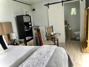 a bedroom with a bed and a table and a toilet at Map's View Guesthouse in Johannesburg