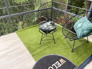 two chairs sitting on top of a patch of grass at Map's View Guesthouse in Johannesburg