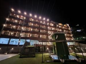 ein Gebäude mit Lichtern in der Nacht in der Unterkunft Golden Fern Resort in Shimla