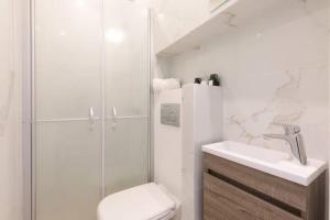 a bathroom with a shower and a toilet and a sink at LE PETIT MARCHE - NEW 2021 Fabuleux studio 2Pax Wi-fi A/C in Antibes +8 photos