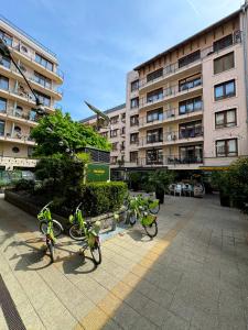 three bikes parked in front of a building at NOVO Central Apartments in Budapest