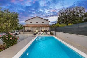 a house with a swimming pool in front of a house at House Katarina with private swiming pool in Pula