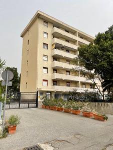 a large building with plants in front of it at Pellarooms Quality Beb in Pellaro