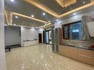 a large room with a large kitchen with a sink at Paradise rooms in Lucknow