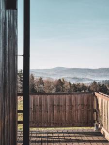 a room with a wooden fence with a view at Nomads' Hill in Poraż