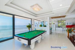 a pool table in a room with a view of the ocean at WhiteDay Villages SÁT BIỂN Trần Phú in Vung Tau