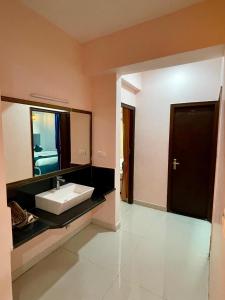 a bathroom with a sink and a mirror at Royal Rajvilas Heights in Udaipur
