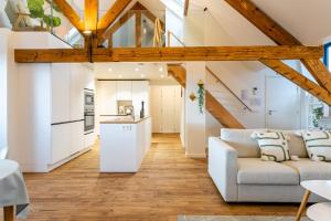 Loft Gent في خنت: غرفة معيشة مع أريكة ومطبخ