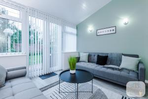 a living room with a couch and a table at Jade House, Manchester - by Synergy Estates in Manchester