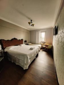 a bedroom with two beds and a window at Seringal Hotel in Manaus