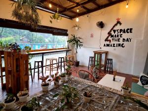 a room with a table with plants on the wall at V Space CAPSULE CAFE MELAKA in Malacca