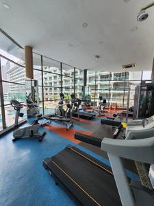 a gym with a bunch of treadms and cardio machines at 2-4 Pax Spacious Living @ Mount Austin, JB #02 in Johor Bahru