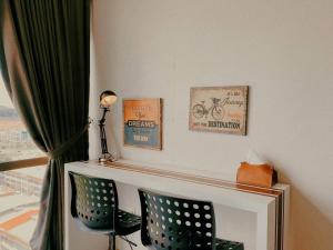 a living room with two chairs and a fireplace at 2-4 Pax Spacious Living @ Mount Austin, JB #02 in Johor Bahru
