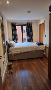a bedroom with a bed with a large window at Two Bedroom Flat B1 Birmingham ( Parking ) in Birmingham