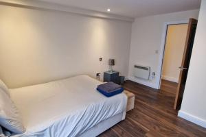 Un dormitorio con una cama con una bolsa azul. en Two Bedroom Flat B1 Birmingham ( Parking ), en Birmingham