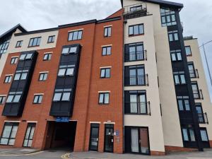 a large red brick building with a garage at Two Bedroom Flat B1 Birmingham ( Parking ) in Birmingham