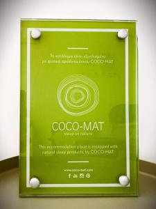 a sign for a coo mat on a table at Κallisto rooms in Mytakas