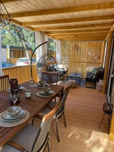 a wooden table and chairs on a wooden deck at mobile home MIRNA in Biograd na Moru