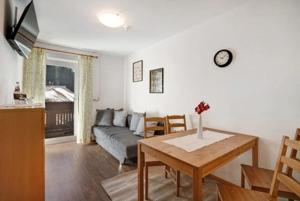 a living room with a couch and a table at Gasthof Innerwalten in San Leonardo in Passiria