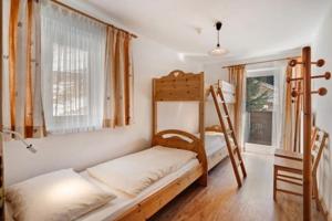 a bedroom with two bunk beds and a window at Gasthof Innerwalten in San Leonardo in Passiria