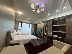 Pokój hotelowy z łóżkiem i biurkiem w obiekcie Guangzhou City Inn Hotel Apartment Pazhou w Guangzhou