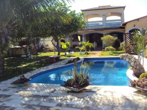 a swimming pool in front of a house at Casa Litoral Sul - Praia Bela/ PB in Pitimbu