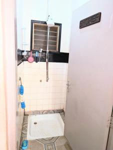 a small bathroom with a toilet in a stall at Dans place in Moshi