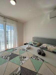 a room with two beds and a tiled floor at Mostar in Mostar
