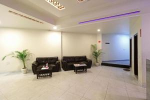 a living room with couches and tables and a lobby at Hotel Classic Plaza at Delhi Airport in New Delhi