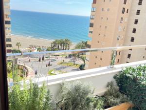a view of the beach from a balcony of a building at Playamar Feliz in Torremolinos