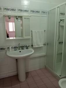 a bathroom with a sink and a shower at Terrazza Faraglioni in Acitrezza