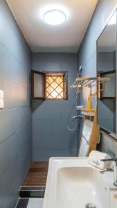 a bathroom with a sink and a window at LE VAHINÉ Eco-RESORT in Toliara