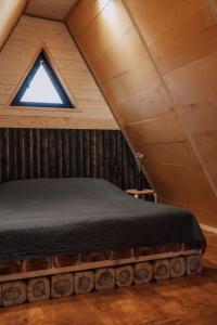 a bedroom with a bed in a attic at BlackWood A frame in Nurrnus