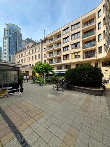 a large building with bikes parked in front of it at NOVO Central Apartments in Budapest